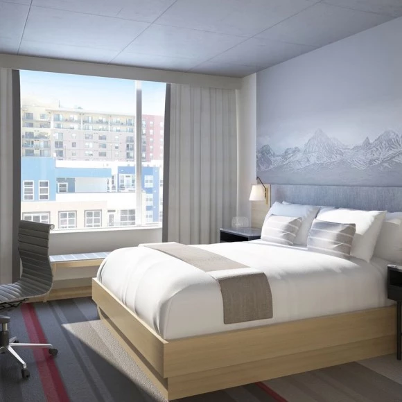 king bed with large window letting in bright sunshine
