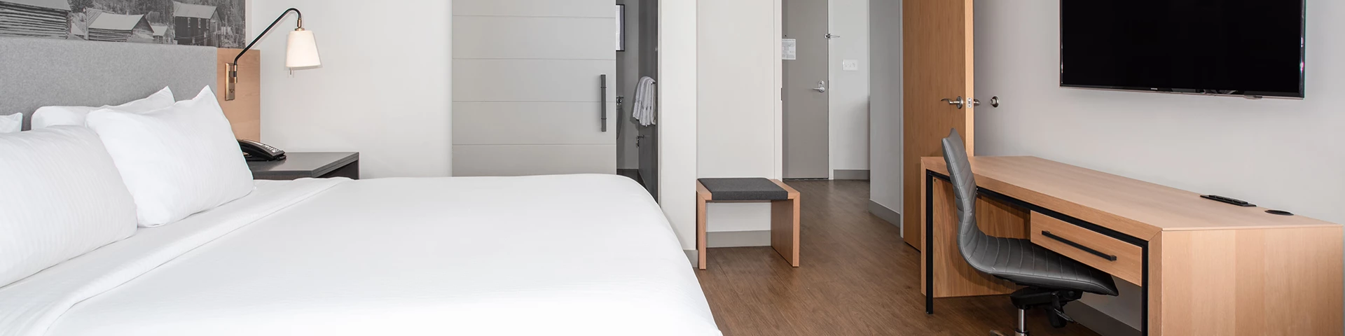 a room with a bed desk and a chair