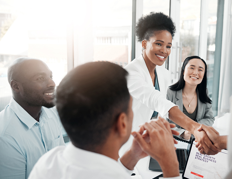 a woman shaking hands with a group of people