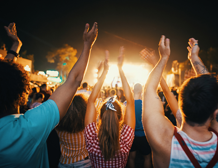 a group of people with their hands up in the air