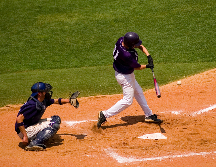 a baseball player swinging his bat