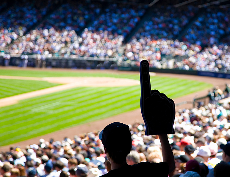 a person holding up their finger in front of a crowd of people