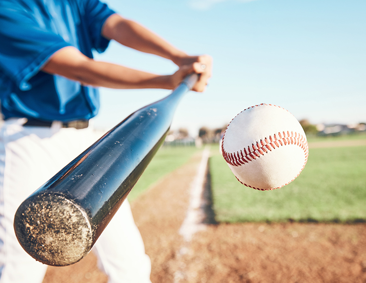 a baseball player hitting a ball with a bat