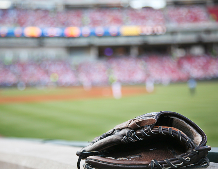 a baseball glove on a railing in a stadium