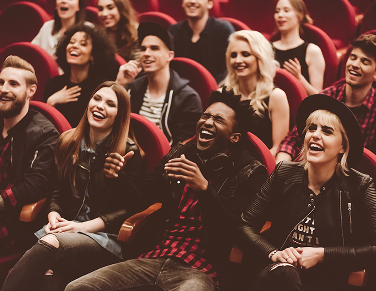a group of people laughing in a movie theater