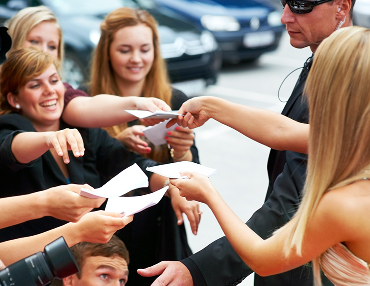 a group of people receiving papers