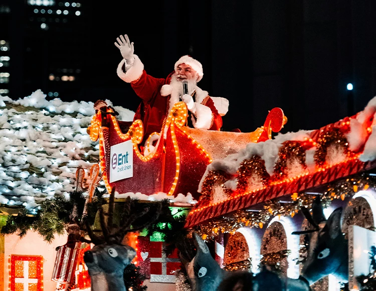 a man in a santa claus garment on a float