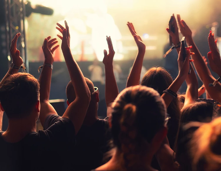 a group of people with their hands up in the air