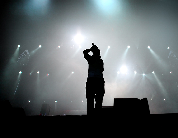 a person on a stage with lights
