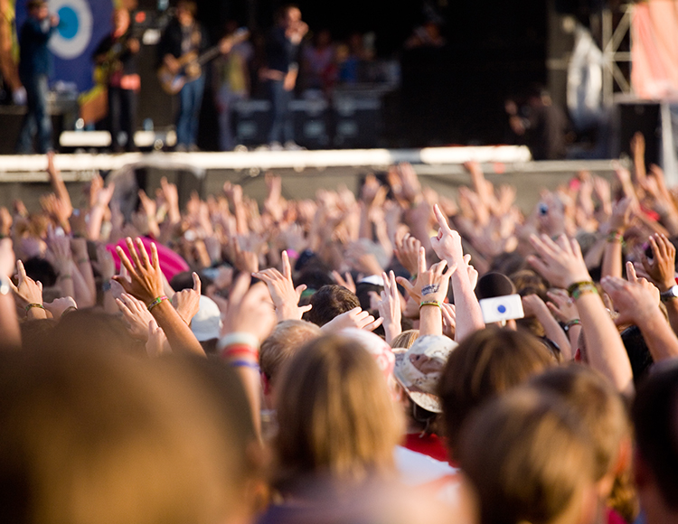 a crowd of people raising their hands
