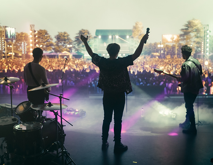 a group of people on a stage with microphones and drums