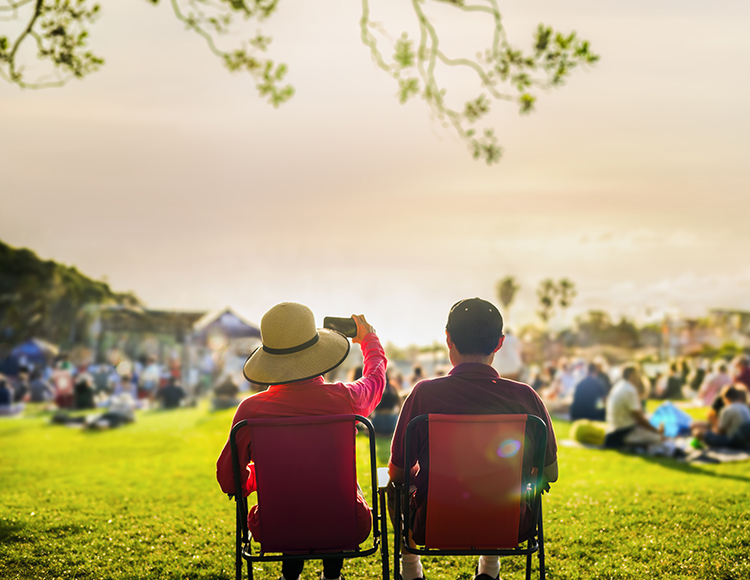 a couple of people sitting in lawn chairs