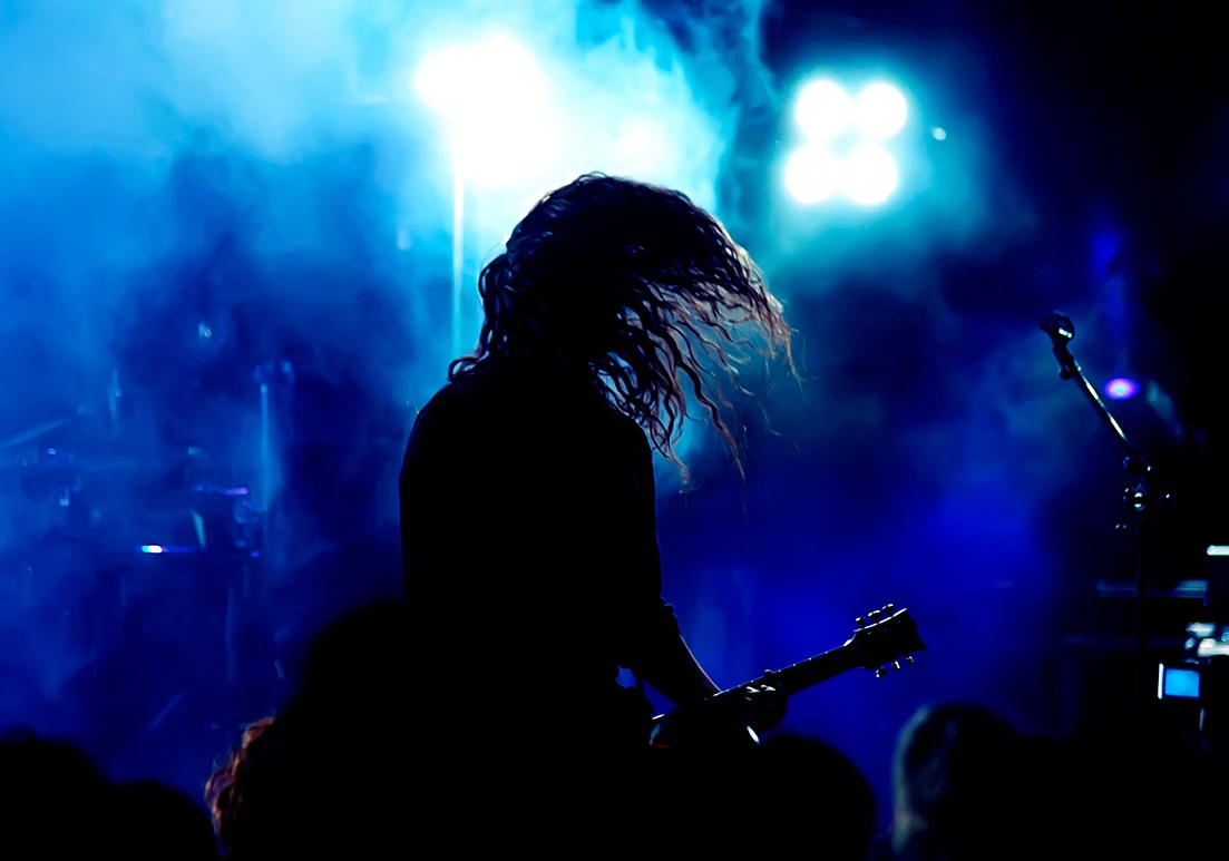 a person playing guitar on a stage