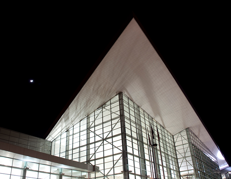 a building with glass walls and a triangular roof