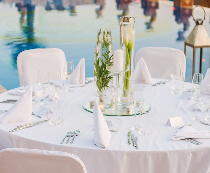 a table set with white napkins and silverware