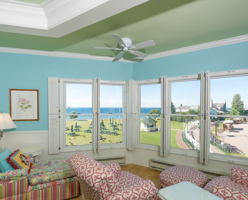 a living room with a view of the beach and a golf course