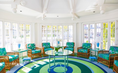 a room with a round table and chairs