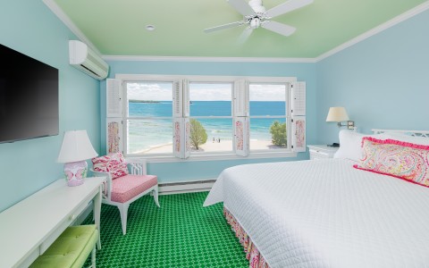 a bedroom with a bed and a window overlooking the ocean