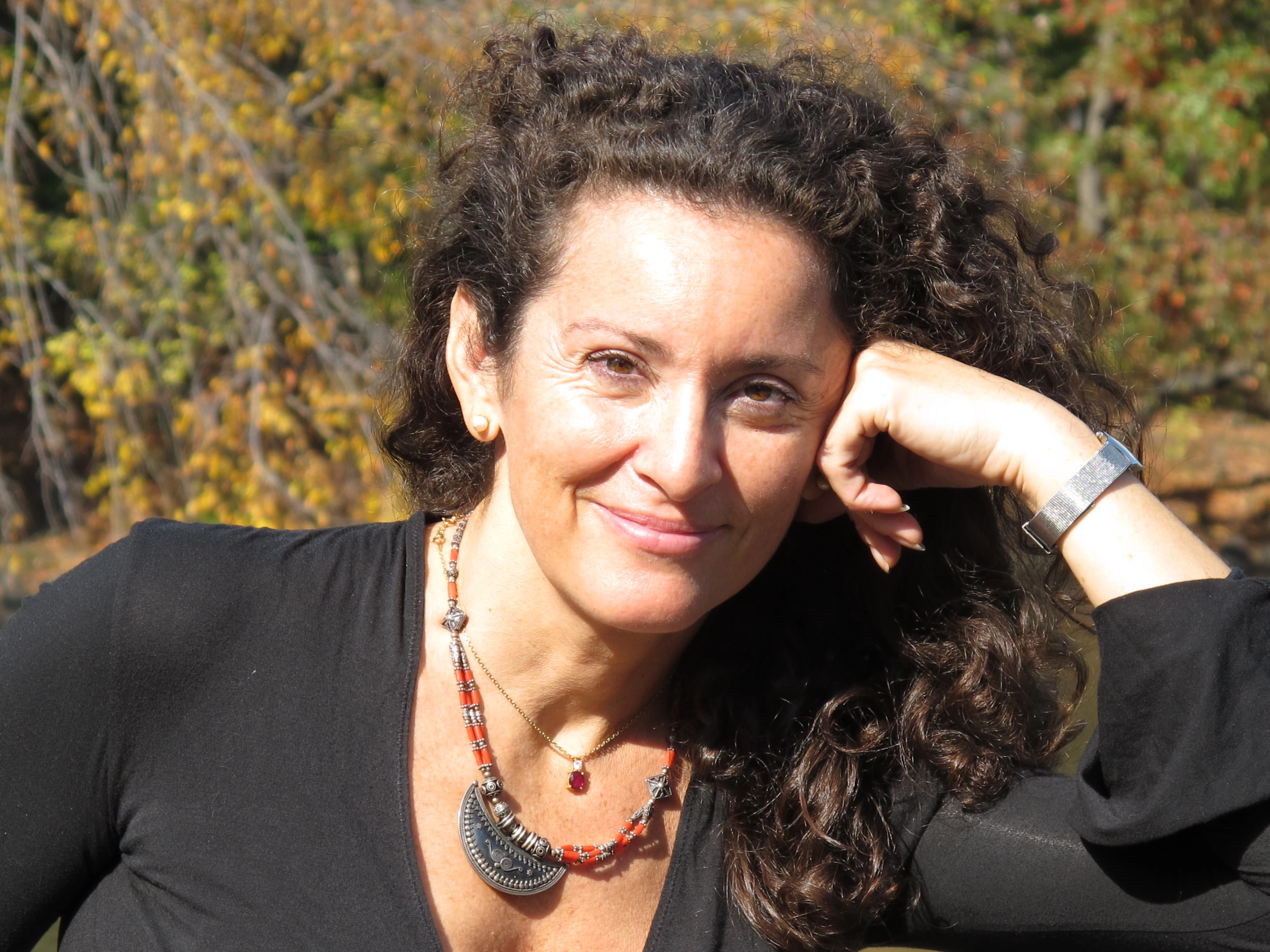 a woman with curly hair and a black shirt