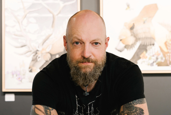 a man with a beard and tattoos