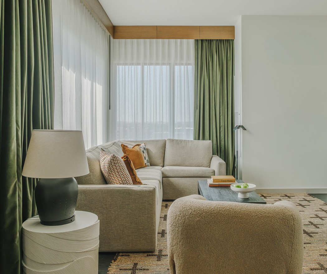 a living room with a couch and a lamp