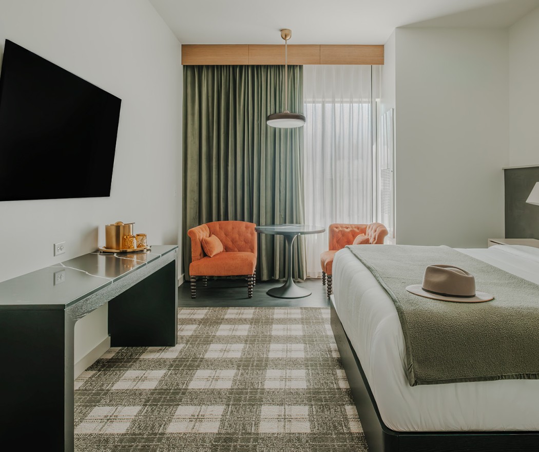 a room with a bed and a table and chairs