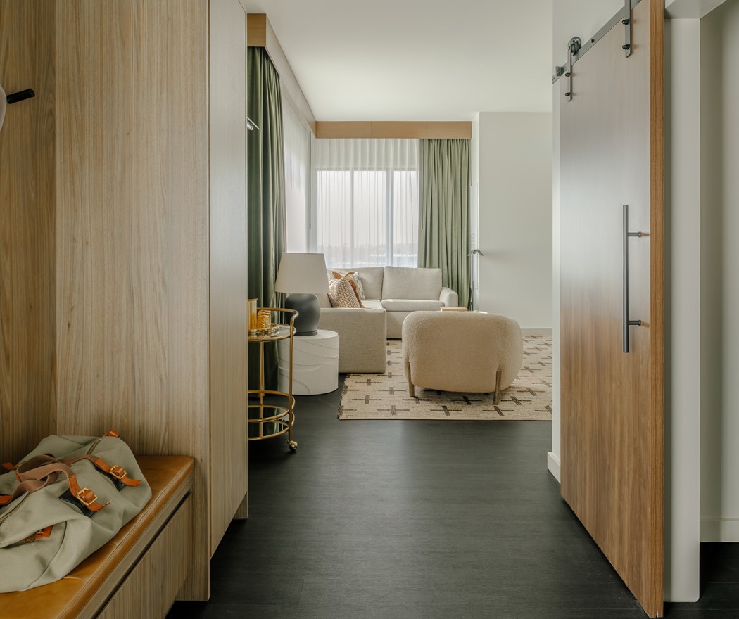 a room with a door and couches