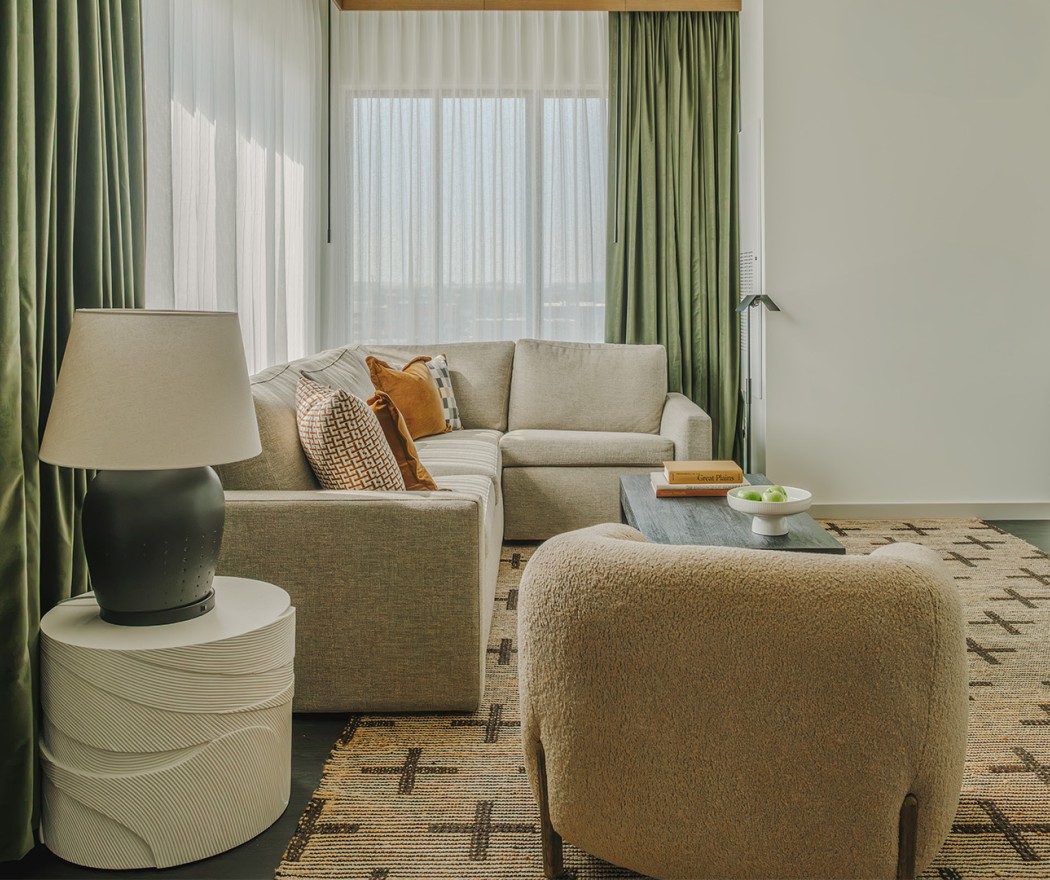 a living room with a couch and a lamp