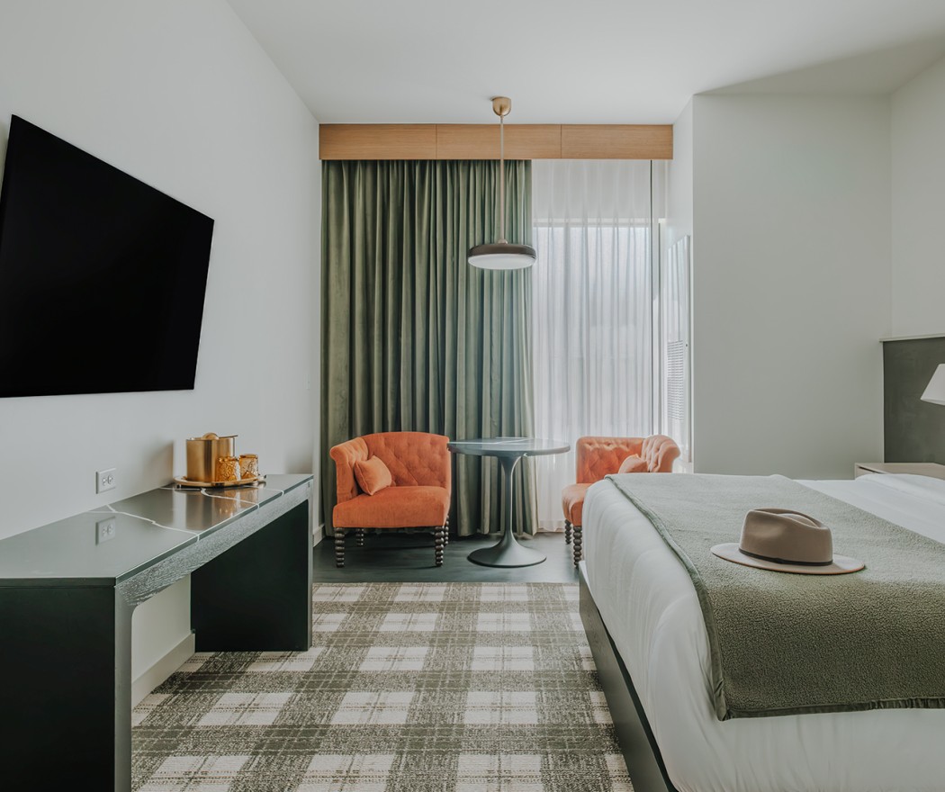a room with a bed and a table and chair