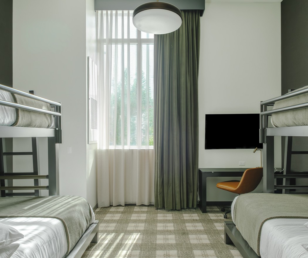a room with bunk beds and a tv