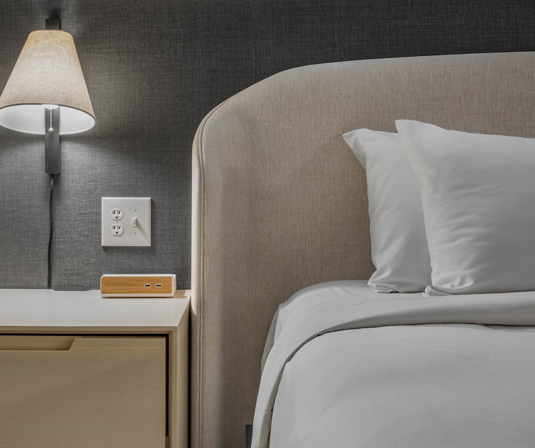 a bed with a lamp and a nightstand