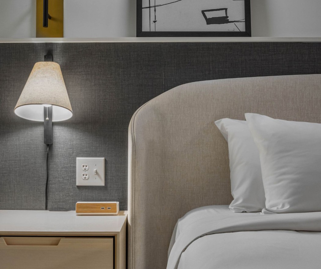 a bed with a lamp and a table