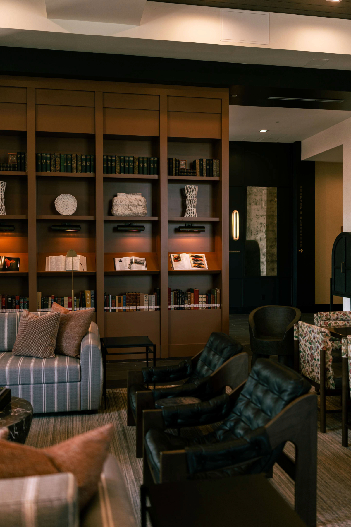 a room with a bookcase and couches