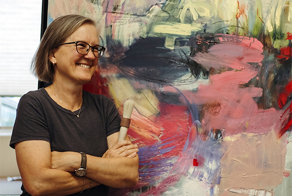 a woman smiling with her arms crossed