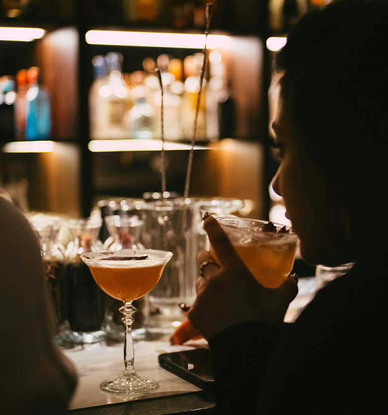 a woman holding a drink