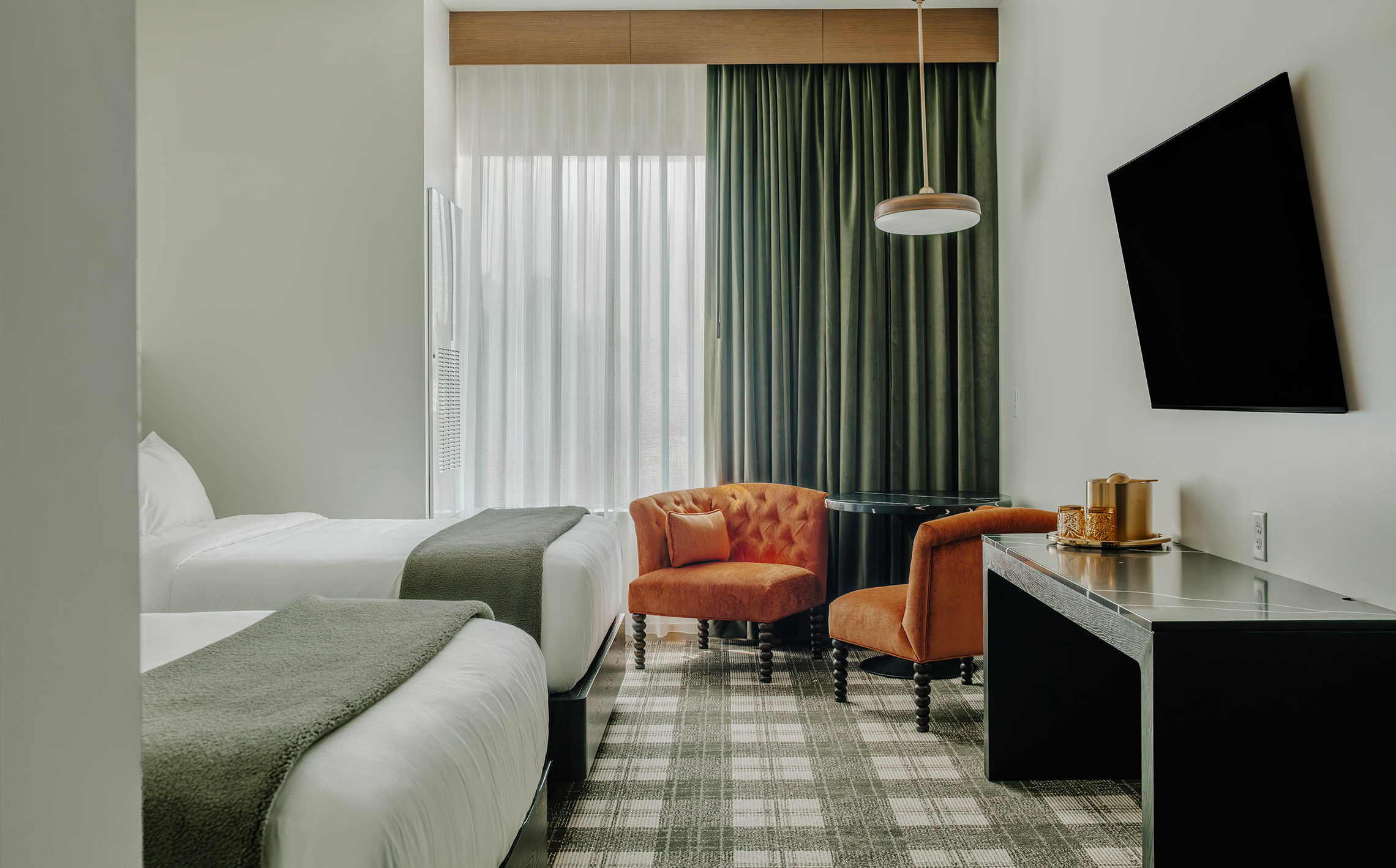 a room with two beds and a tv