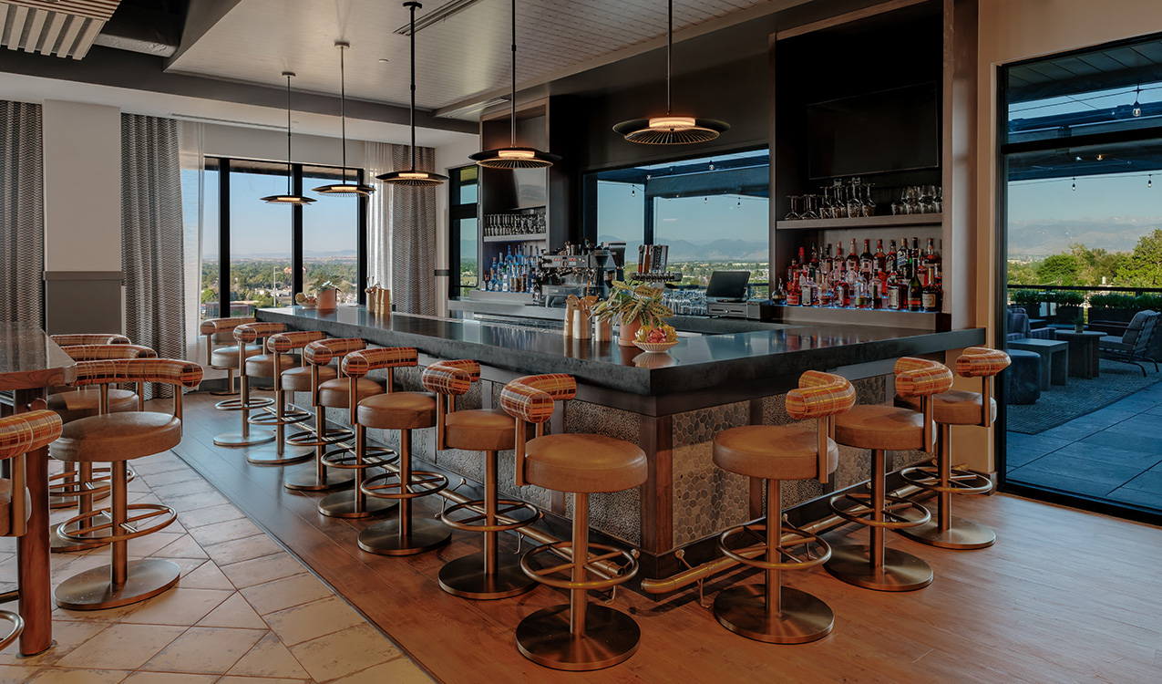 a bar with chairs and a large counter