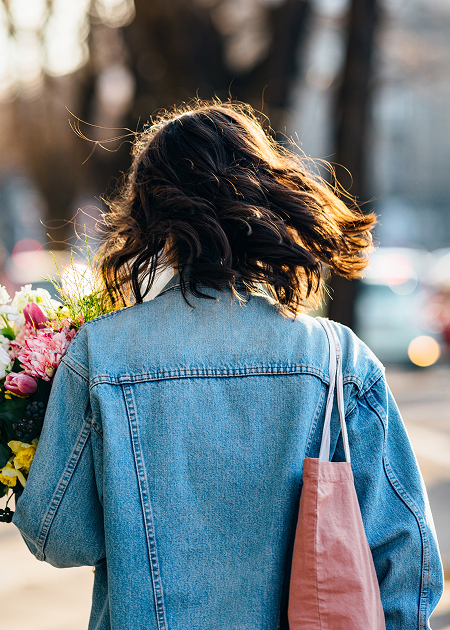 a woman carrying a bouquet of flowers