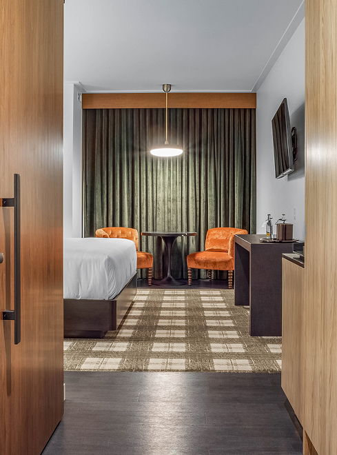 a room with a bed and a table and chairs