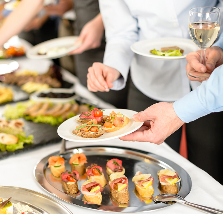 a group of people holding plates of food