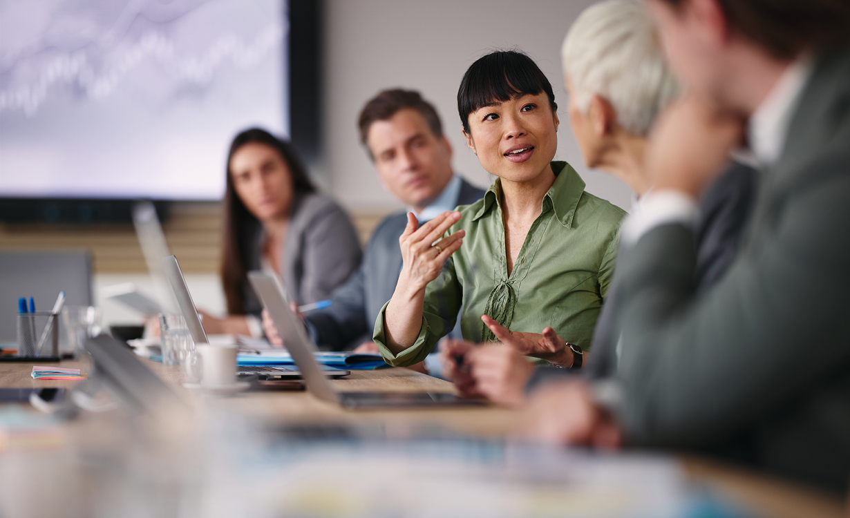 a woman talking to a group of people