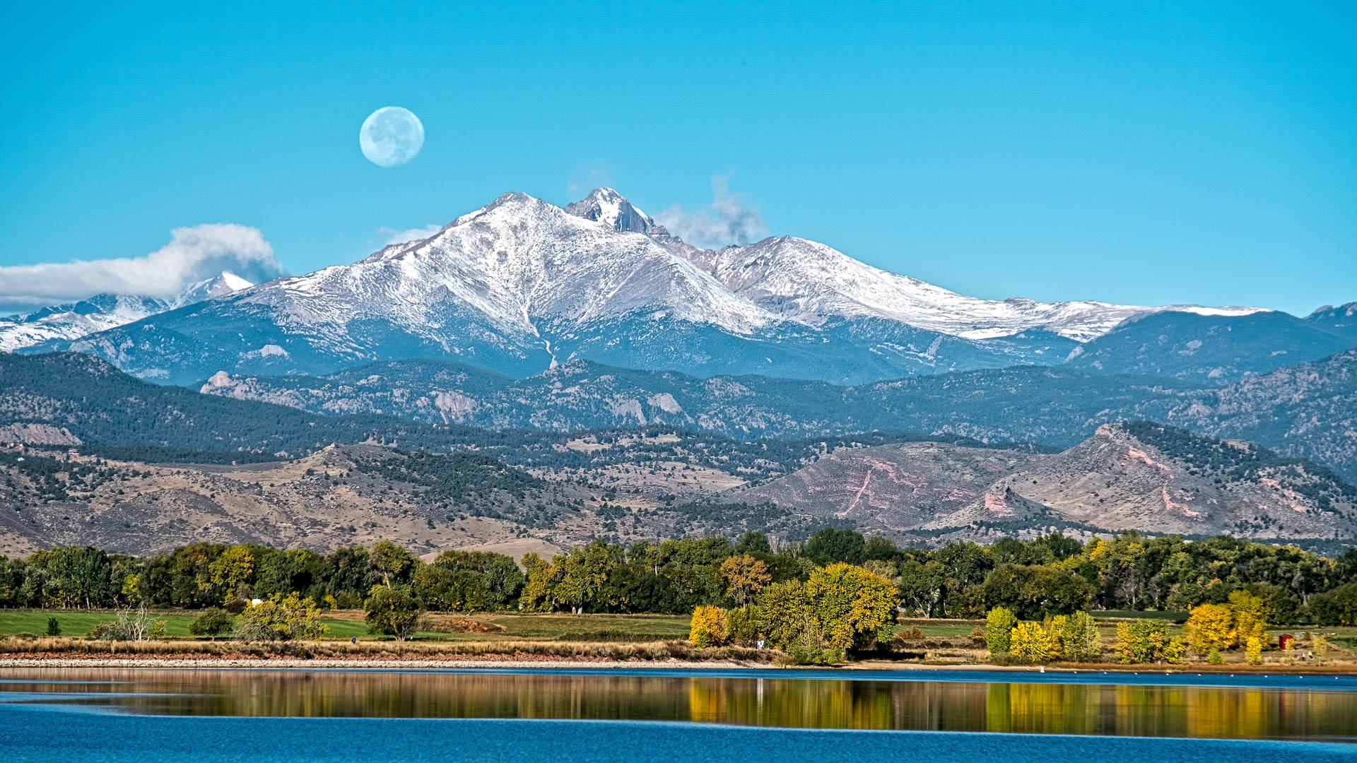 a moon over a mountain