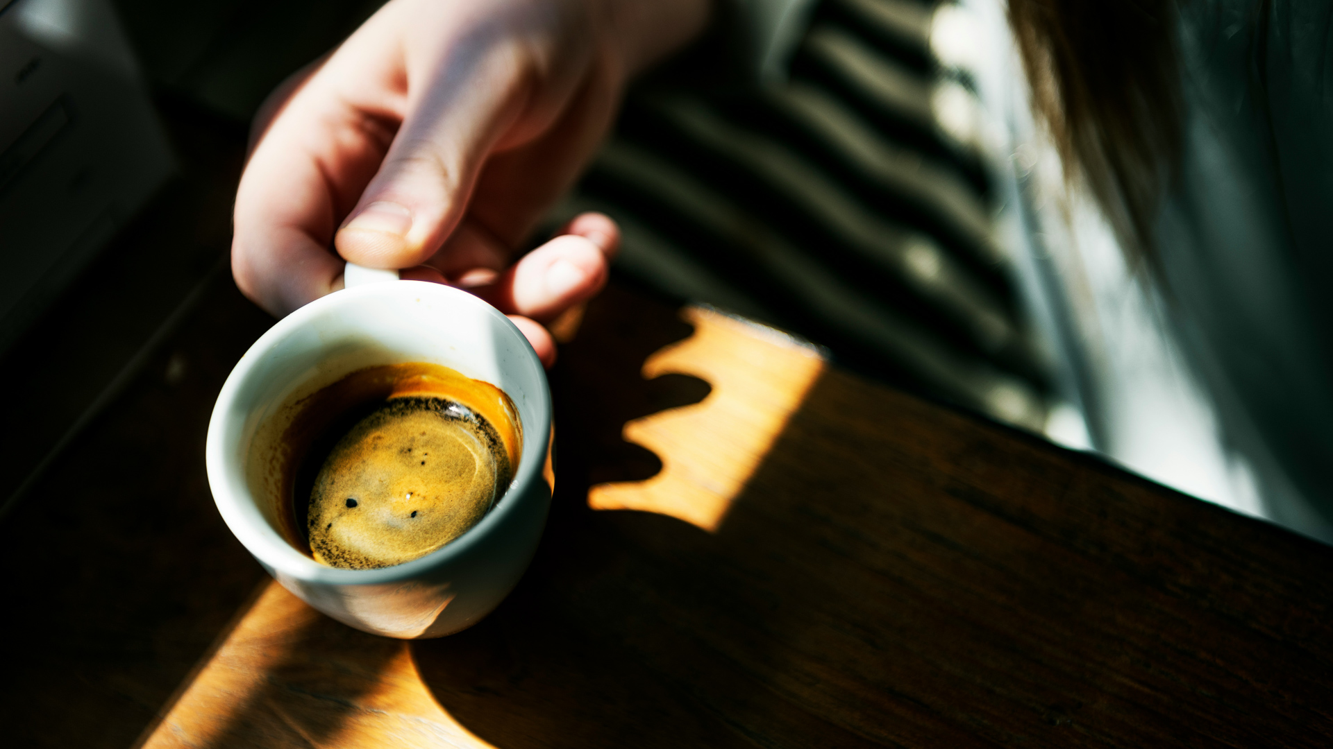 a person holding a cup of coffee