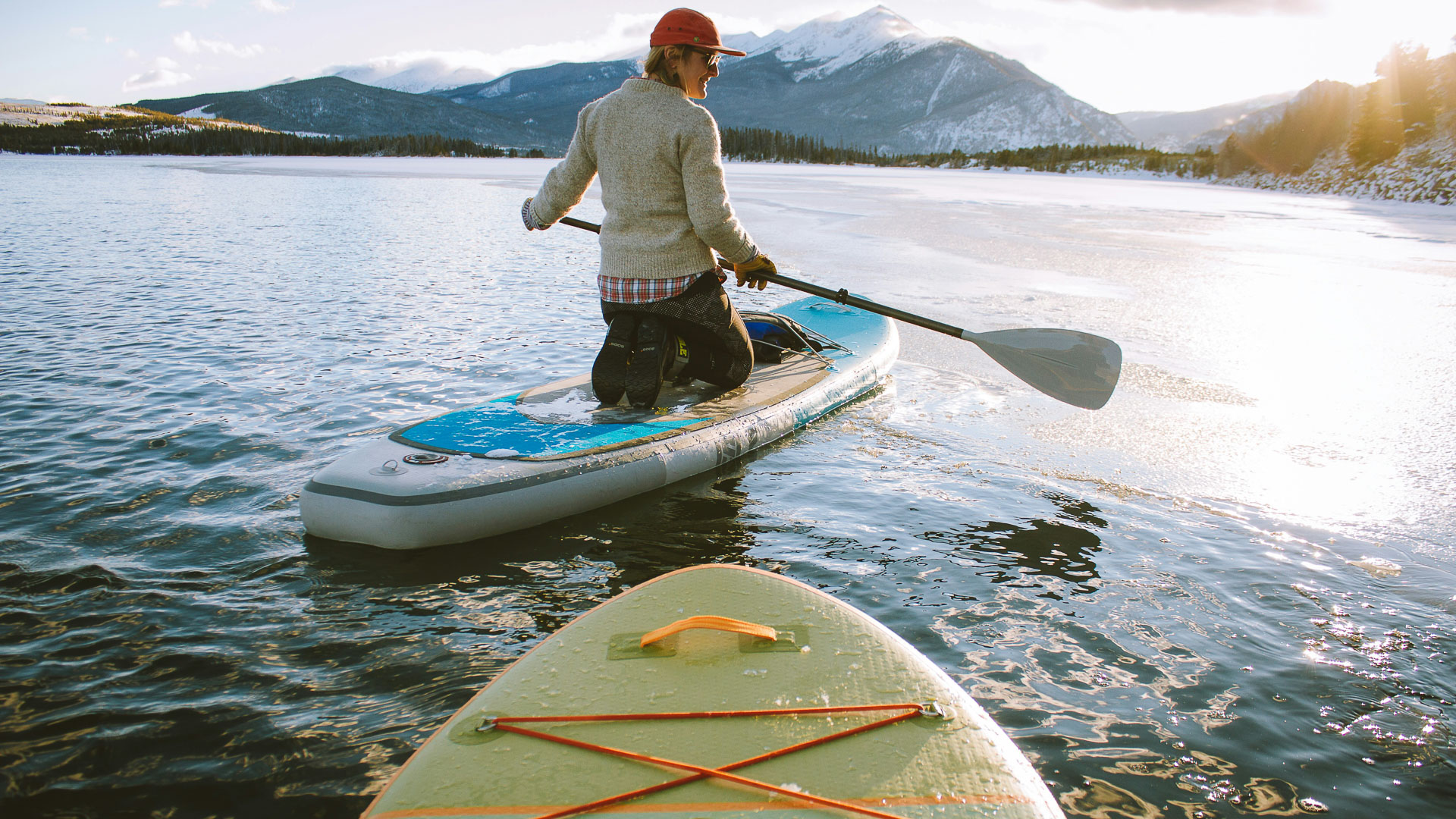a person on a paddle board on a lake