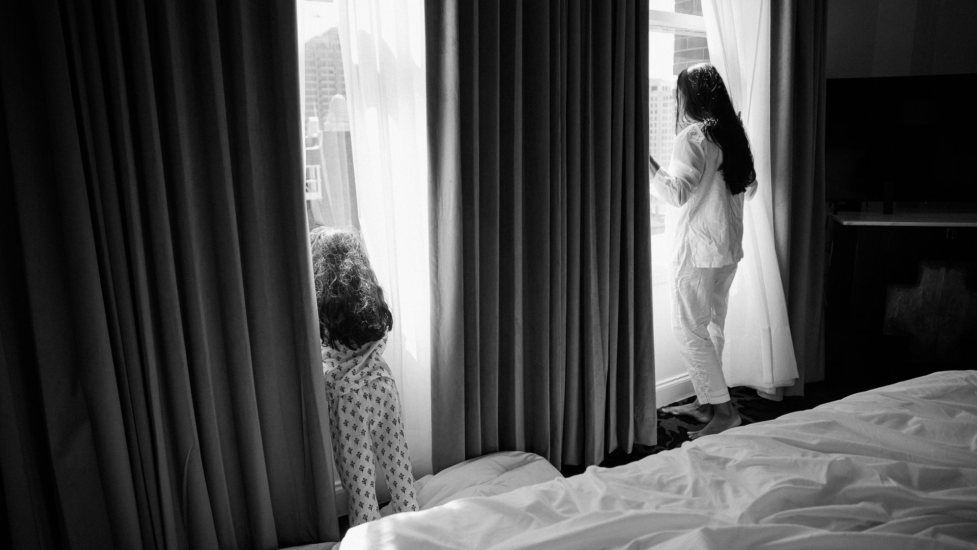 a woman and child looking out a window