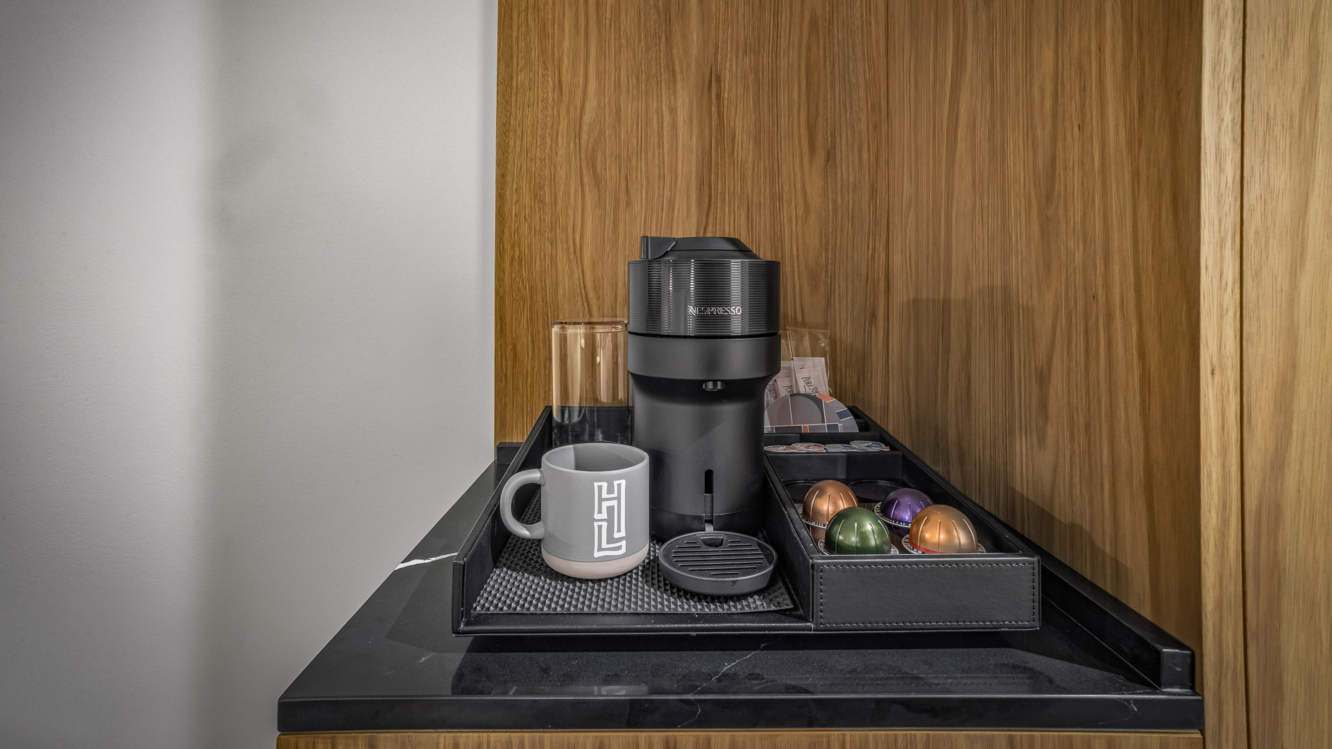 a coffee machine and mugs on a tray