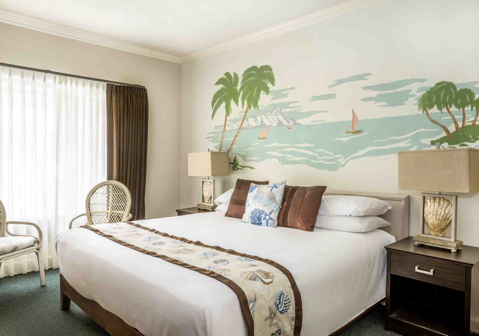 a bed with a palm tree mural on the wall