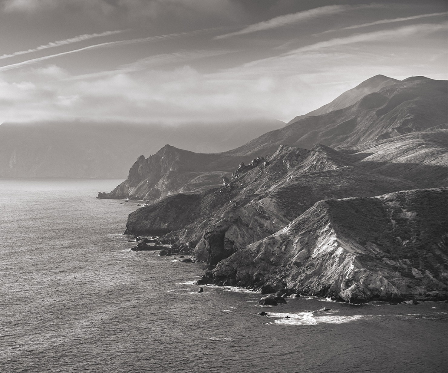 a black and white photo of a rocky coast