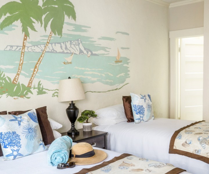 a room with two beds and a lamp