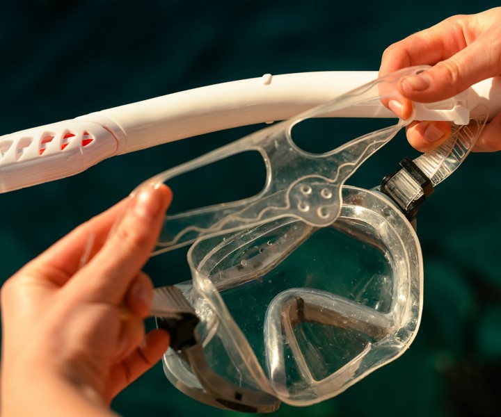 a person holding a mask and snorkel